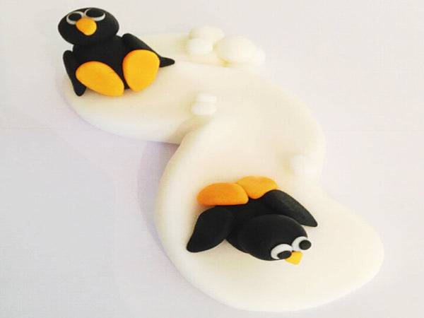Edible penguin slope cake topper